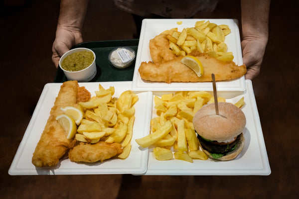 Award winning fish & chips and venison burger on a serving tray served at the Real Food Cafe in Tyndrym Scotland