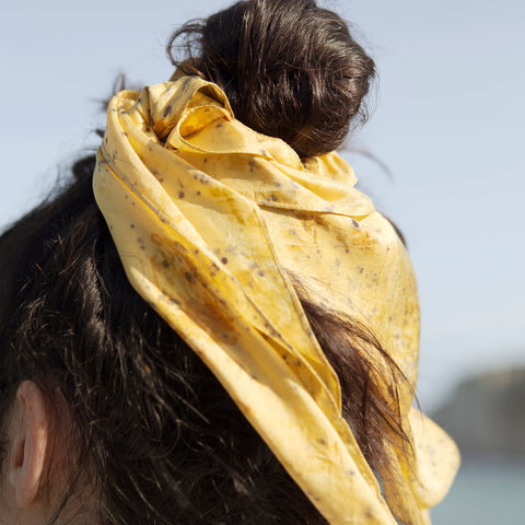 Bun tied with a yellow organic silk scarf
