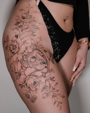 Fine line tattoo of the lion and flowers