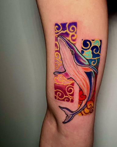 Thin line tattoo of a colorful whale by @valeria.cynath_tattooer