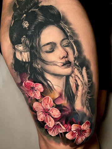 Realistic tattoo of geisha with pink flowers
