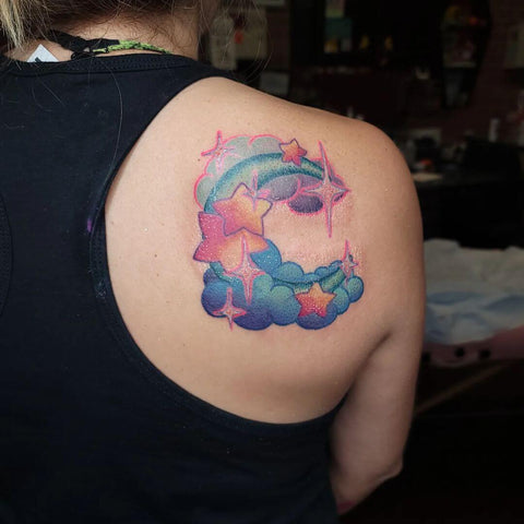 Colorful stars and moon tattoo