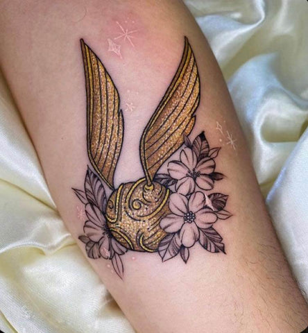 Colorful tattoos of golden flying balls by @Tattoos By Nick