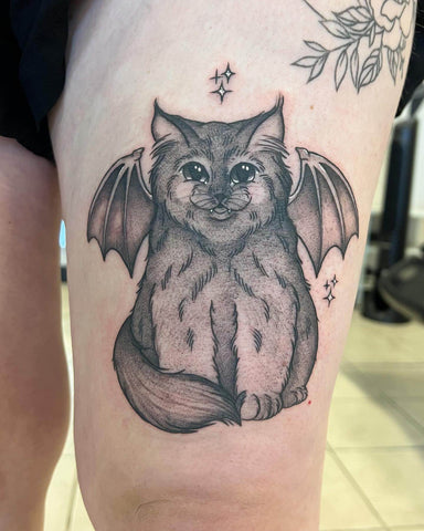 Cat tattoo with bat wings