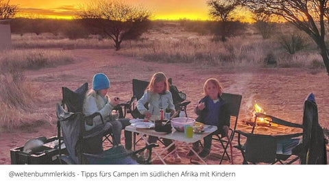 campen-mit-kinden-in-Südafrika-drei-kinder-essen-draußen-am-Tisch