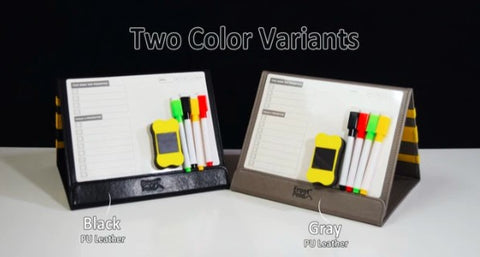 Two Color Variants: white surface with black background, black version of Front Fold is on the left, grey version is on the right. Both show everything included - pens, eraser, whiteboards.