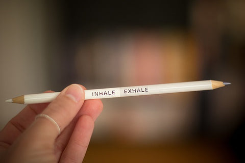 Two-sided pencil: white side has white lead and has INHALE written on it; light grey side has grey lead and EXHALE written on it.