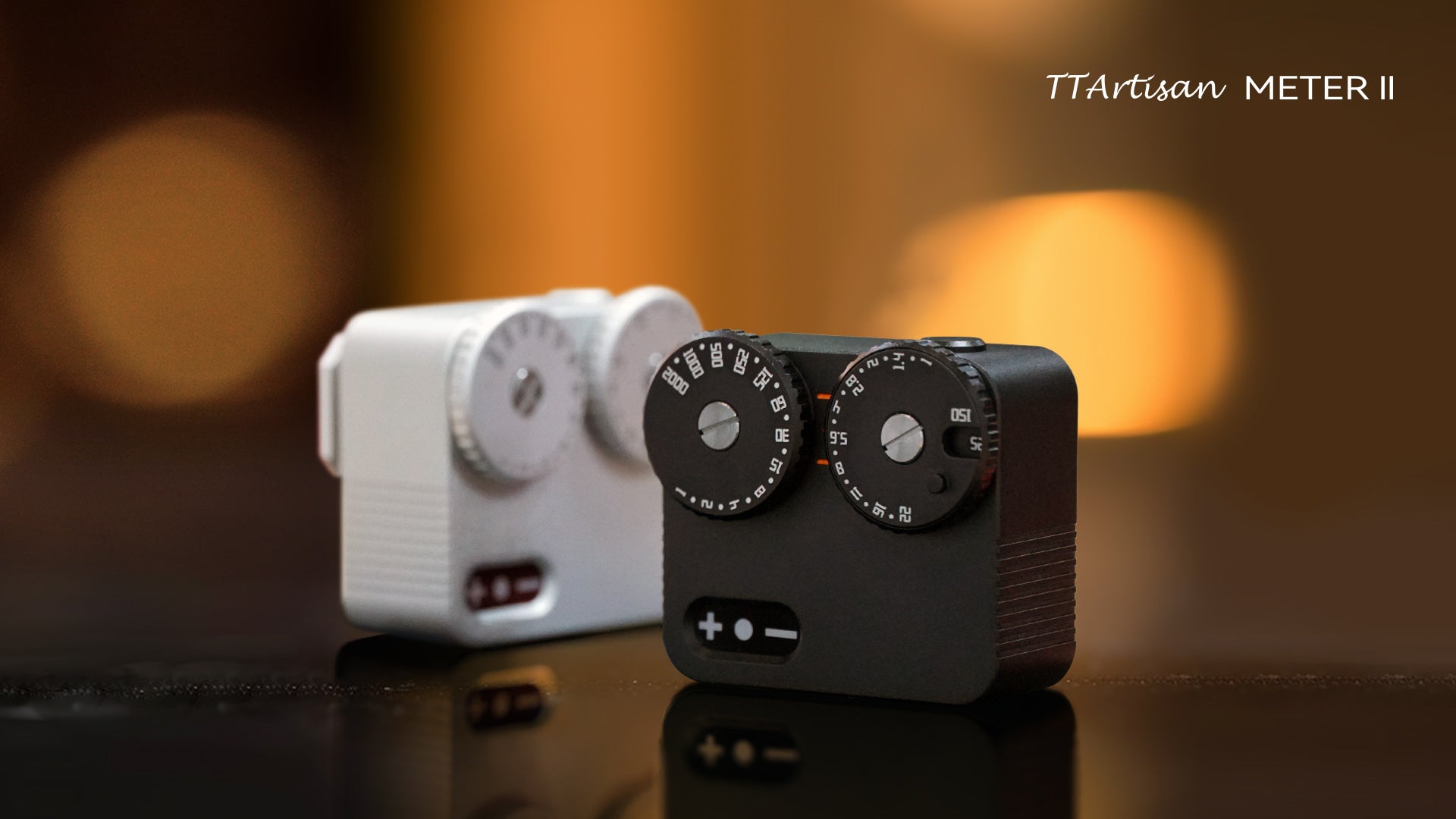 Black and Silver TTartisan Light Meters II on a tabletop