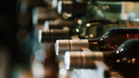 Wine bottles in Fokus in wine cellar