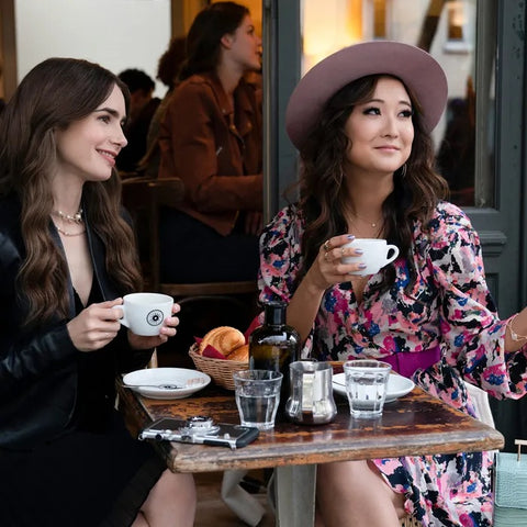 two women drinking coffee together