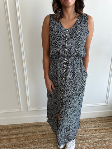 black and white floral loose fitting tank top with white buttons and black and white midi skirt with flower print with side slits with white sneakers