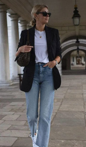 woman wearing a blazer and white tee and jeans