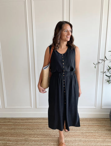 woman wearing flowy tank top and black midi skirt with buttons