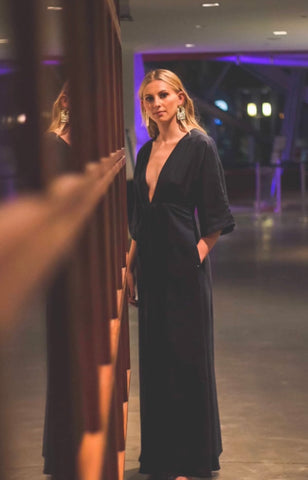 blonde woman wearing deep v-neck navy gown