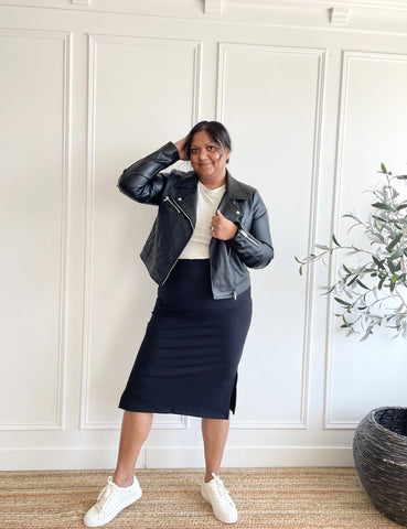 woman wearing moto jacket, grey bamboo t-shirt and black midi skirt