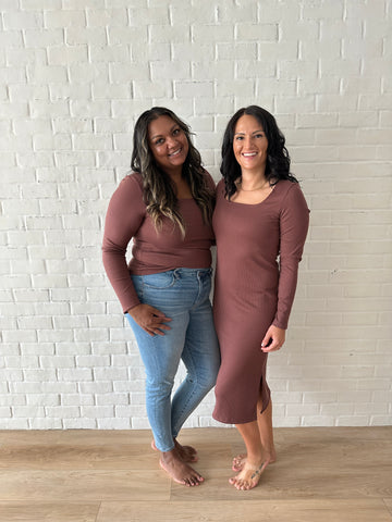 brown woman and white woman standing wearing brown top and jeans and brown long sleeved dress for fall