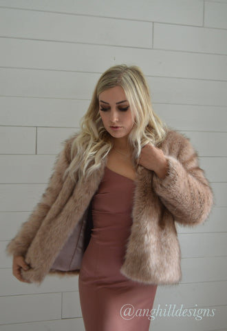 woman wearing fur coat and pink dress
