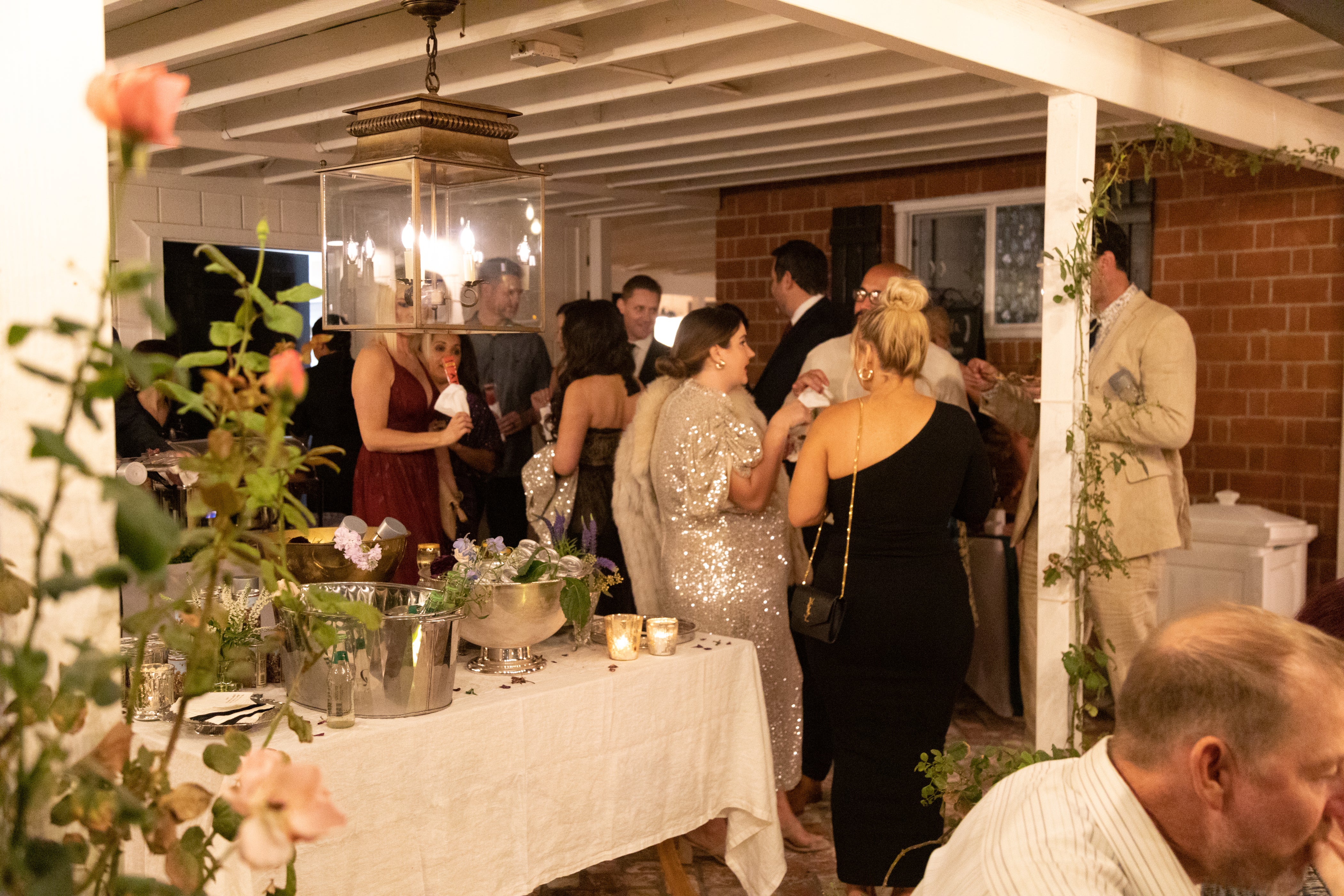 People Gathered Around Under A Covered Patio at The Winter Party