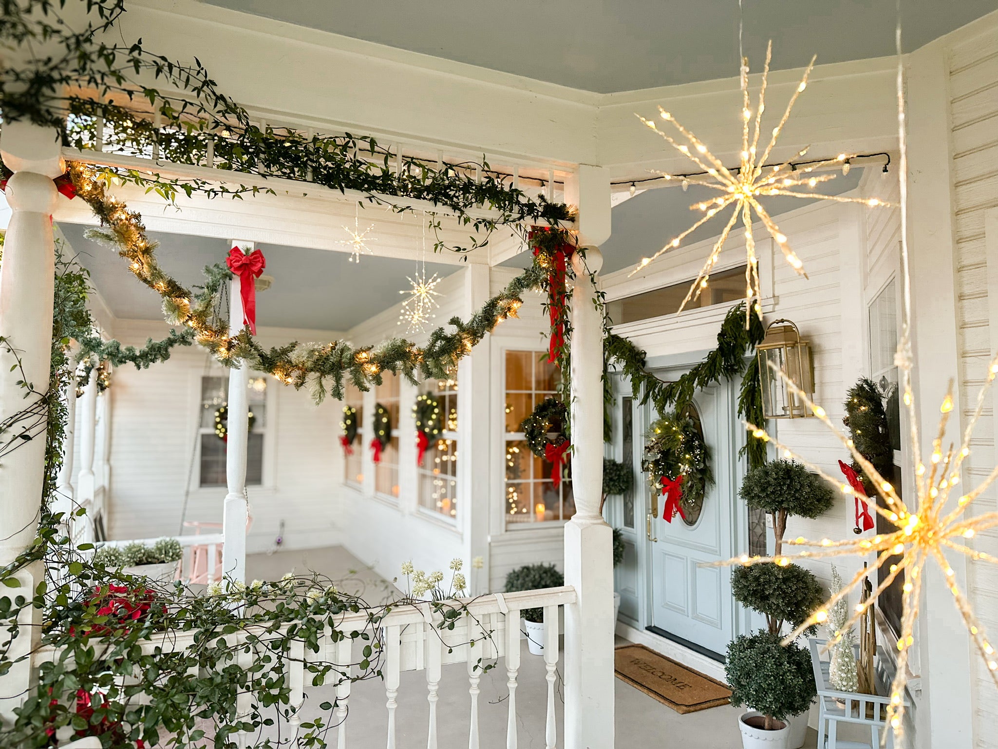 Lights and Garland Hanging From Inside the Porch