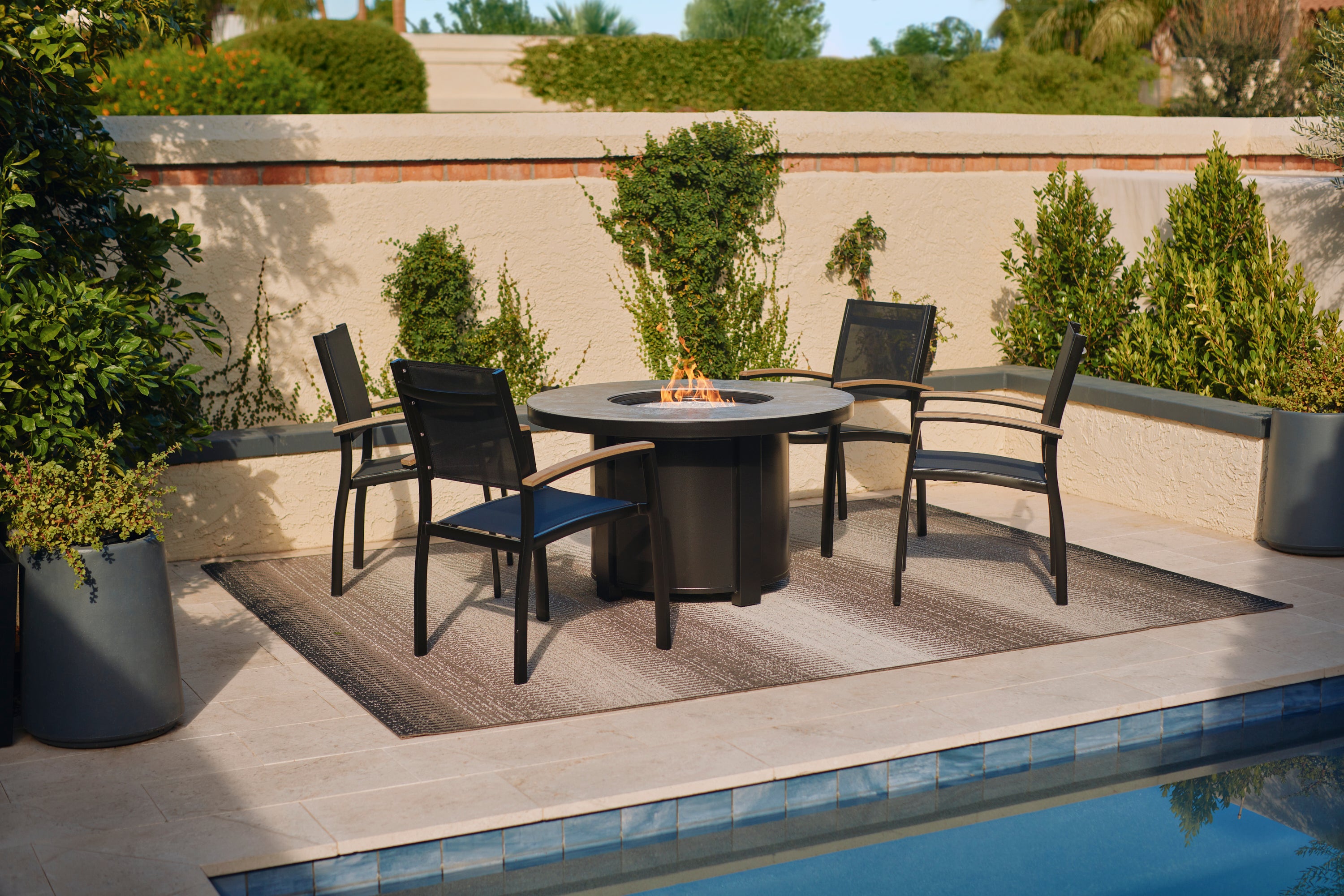Mission Stackable Sling Chairs Around a Bliss Fire Pit Table
