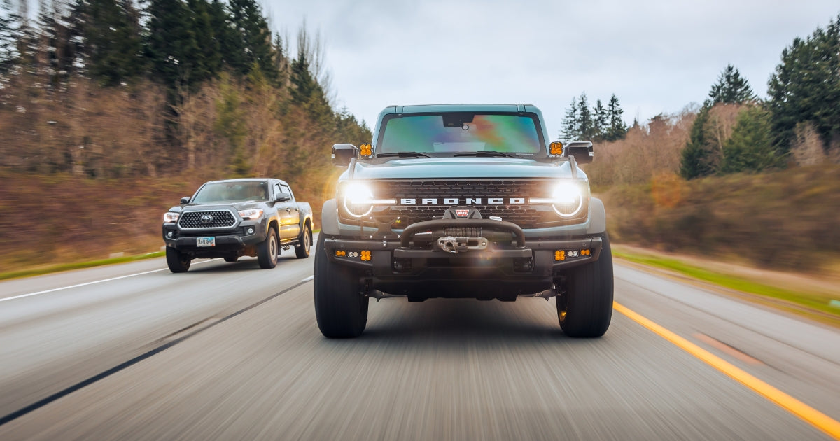 front grill view of a ford bronco on the highway somewhere in the pnw