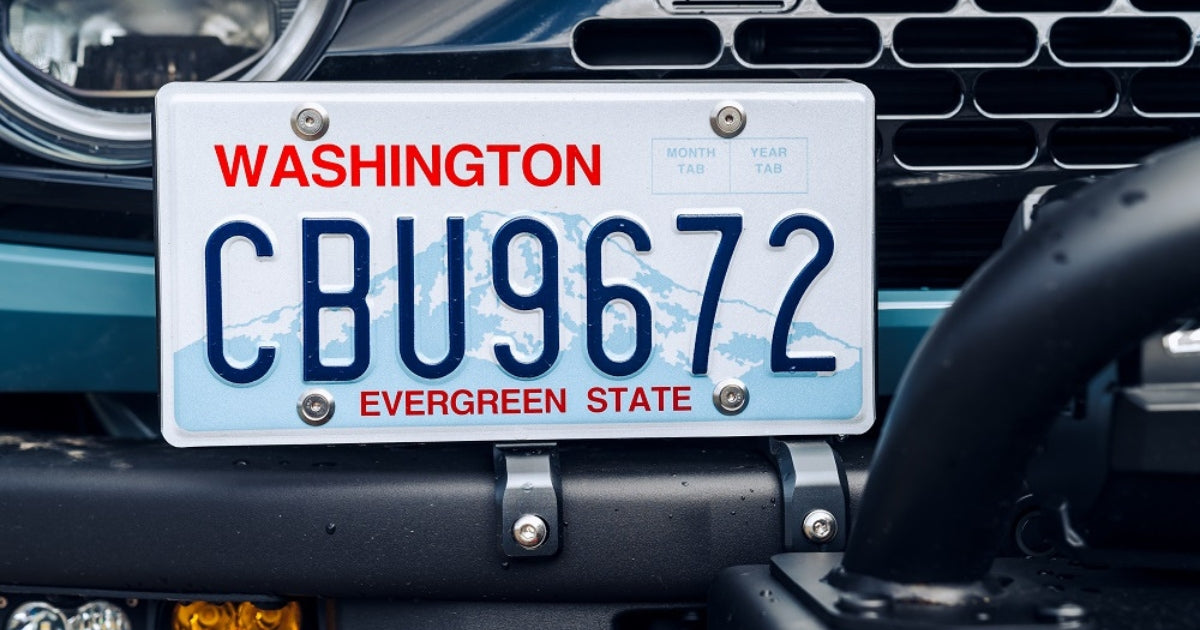 close up of a license plate holder by archetype racing attached to the front of a ford bronco