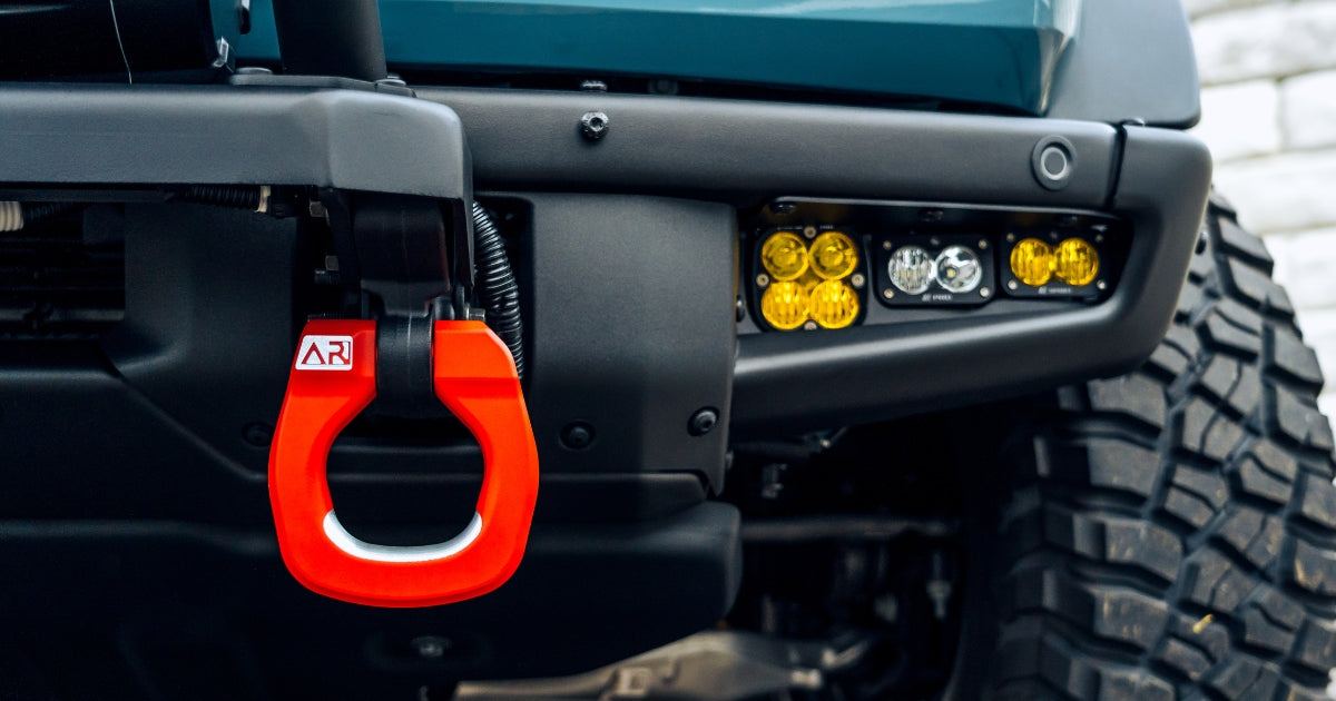close up of archetype racing's red bumper shackle on ford bronco left side of the car