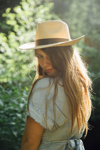 girl wearing hat in nature