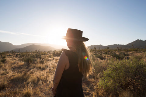 girl wearing hat in desert