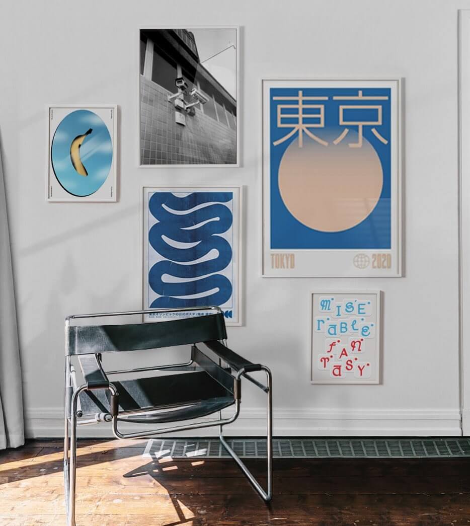 living room with a chair and range of blue hue artworks displayed against a white wall