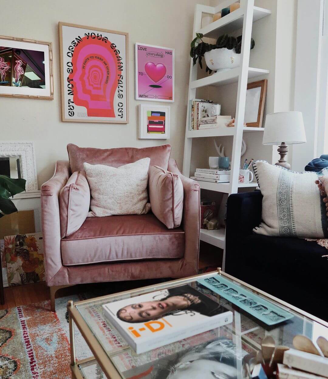 Gallery Wall With Pink And Red Artworks In A Room With A Pink Chair