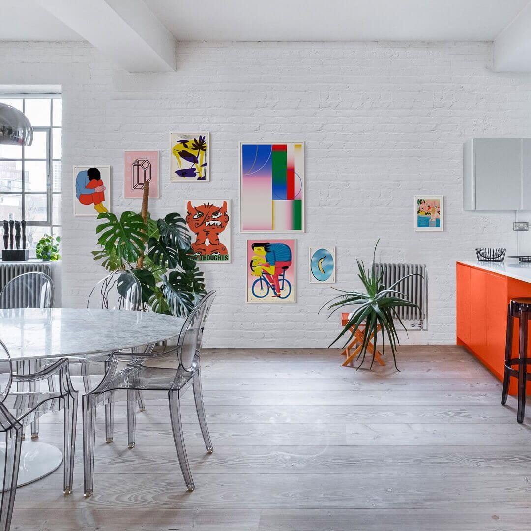 large warehouse flat with white brick walls and contemporary framed artworks