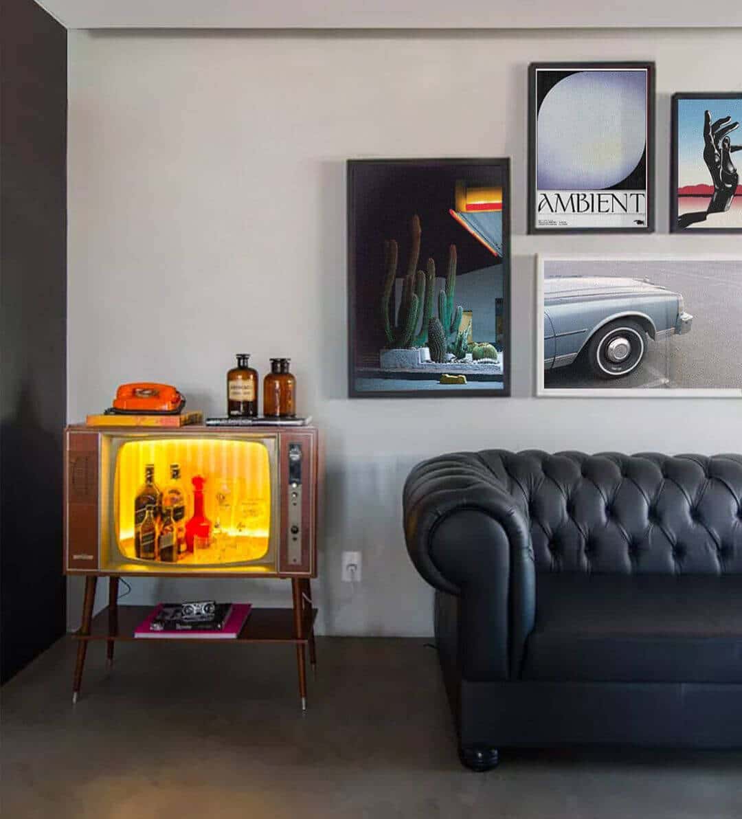 Maximalism Interior with a black leather sofa and contemporary gallery wall