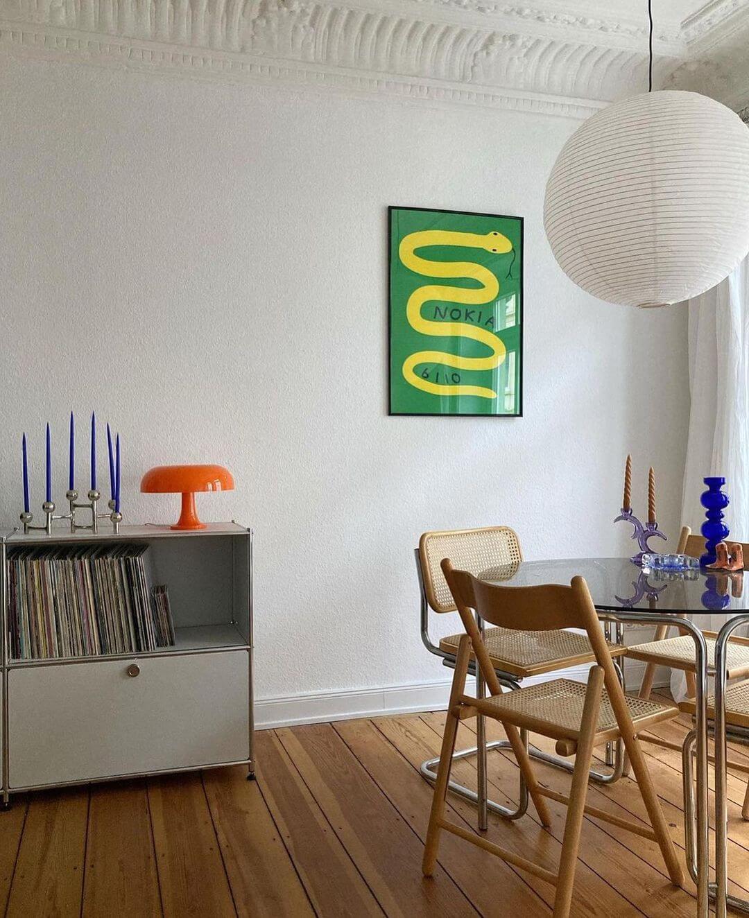 Mid Century Modern Dining Room With Green Snake Artwork Hung On The Wall