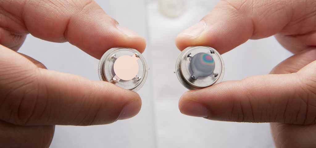 Scientist holding copper and silver OnGuard sensors in their hands