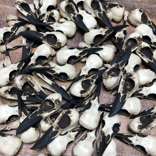 Raven skull necklaces and crow skull necklaces in a pile of bird skull jewelry