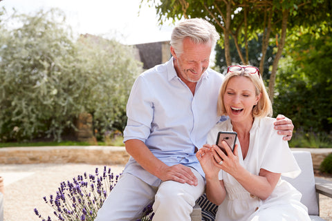 elder couple on phone looking up extension office