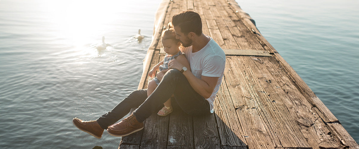 Man on dock talking to daughter about environmental impact