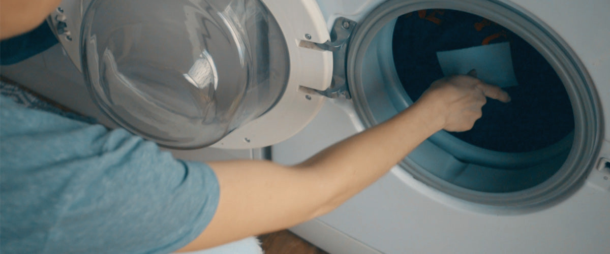 Placing Sheet Yeah! Laundry sheets in the washing machine 