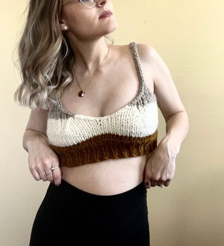 a woman in a crochet bra top and black leggings