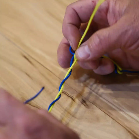 Hold the center of the twists in a blood knot open using the first end of tippet.