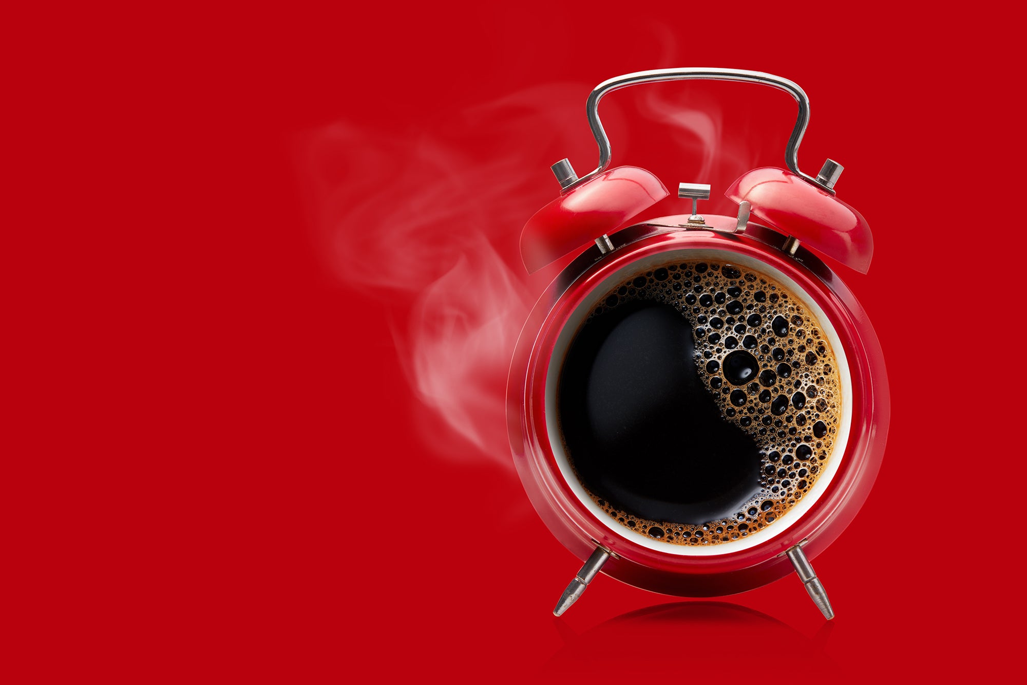 Red alarm clock with steaming coffee as the clock face