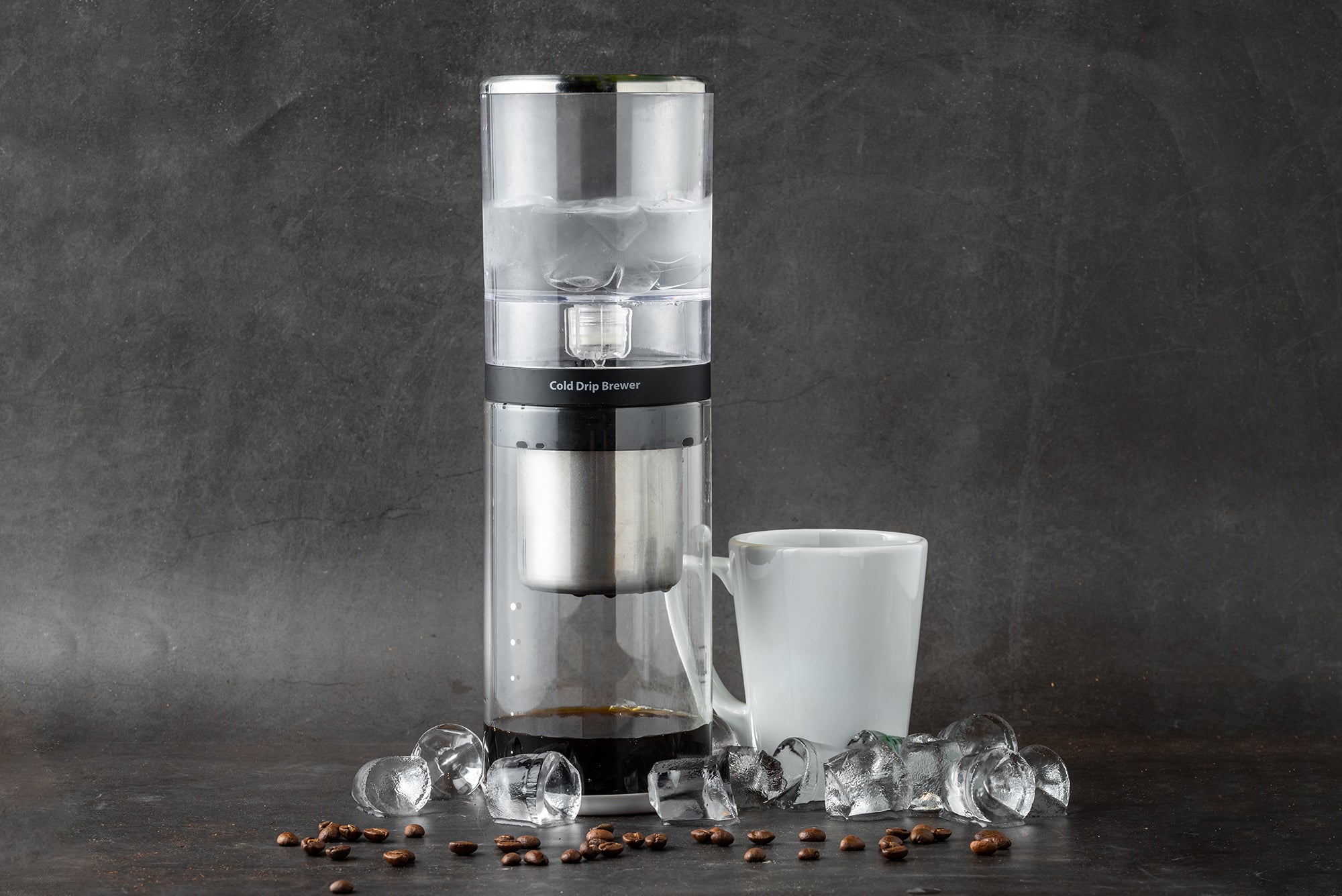 Silver cold brew ice drip machine with white cup and ice