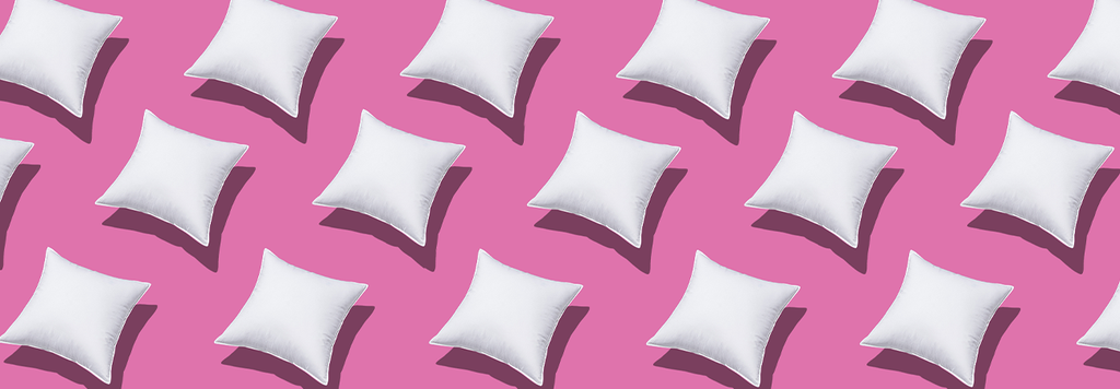 white cushions on a pink background