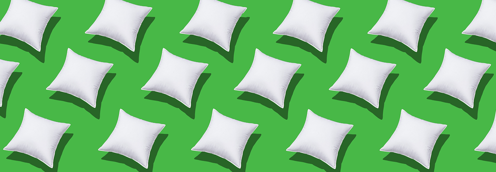 white cushions on green background