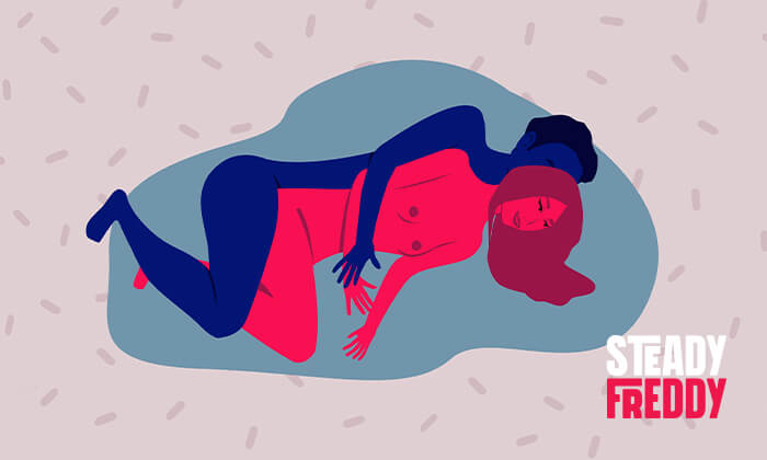Spooning sex position, a man lay behind her, facing the same direction, his hips behind hers.