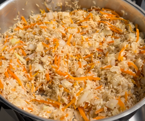 Stir in the rinsed brown rice and cook for 2-3 minutes, until the rice is lightly toasted.