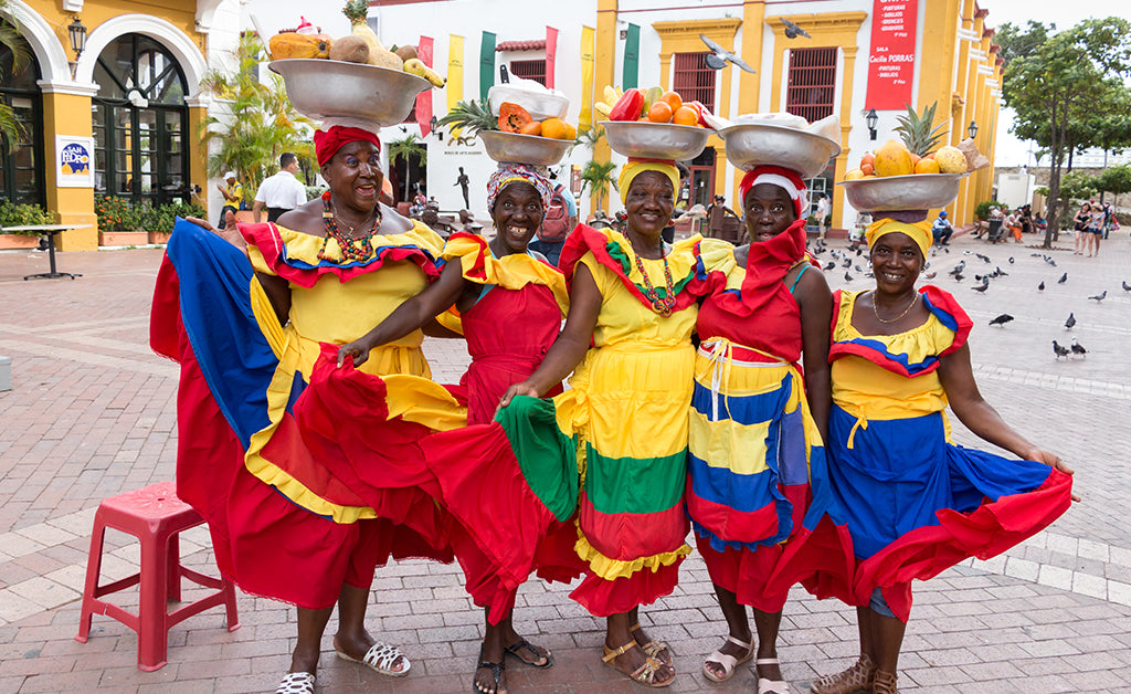 Ladies from Colombia carrying fruit