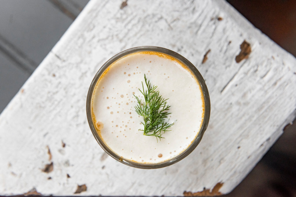 A Hamburger Latte garnished with a sprig of dill