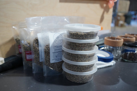 Several samples of green coffee in clear packaging